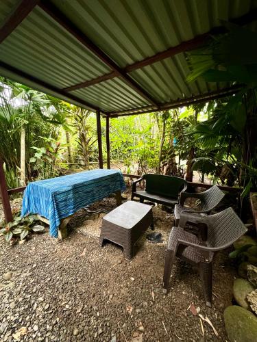 a tent with a bed and a table and chairs at Hidden Jungle Beach House in Puerto Viejo