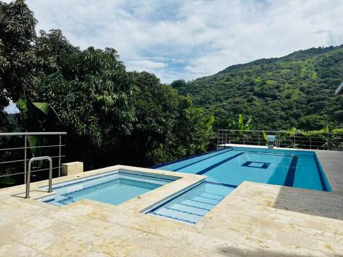 a large swimming pool with a mountain in the background at Finca con Piscina Privada in San Jerónimo