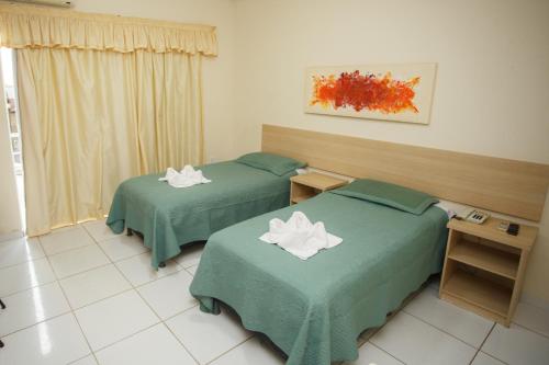 Una cama o camas en una habitación de Starbello Hotel
