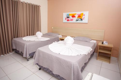 Una cama o camas en una habitación de Starbello Hotel