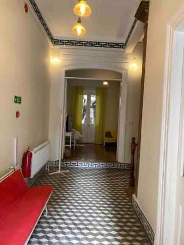 a hallway with a red bench in a room at Maris Alsancak City Center in Konak