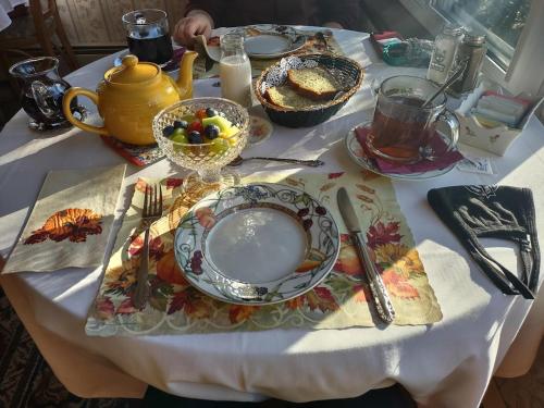 a table with a plate of food on it at Rockwell Falls Inn and Wine Bar in Lake Luzerne