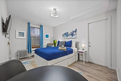 a bedroom with a bed and a table in it at Central Location Studio Walk to Times Square in New York