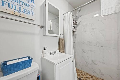 a white bathroom with a toilet and a sink at Central Location Studio Walk to Times Square in New York