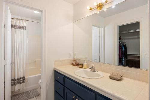 a bathroom with a sink and a mirror at Bonanza in the Desert - Pool, Hot Tub, Grill home in Yucca Valley