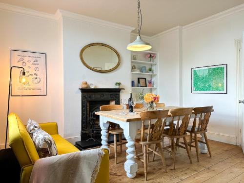 a dining room with a table and chairs and a mirror at NEW Spacious Family Home with Parking & Garden - Sleeps 6 - Perfect for Families in Canterbury