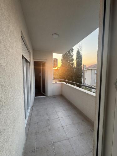 a balcony of a building with a view of the sunset at Apartman Podgorica in Podgorica