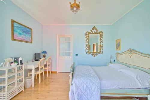 a bedroom with a bed and a desk and a mirror at B&B Villa Botto in Cossato