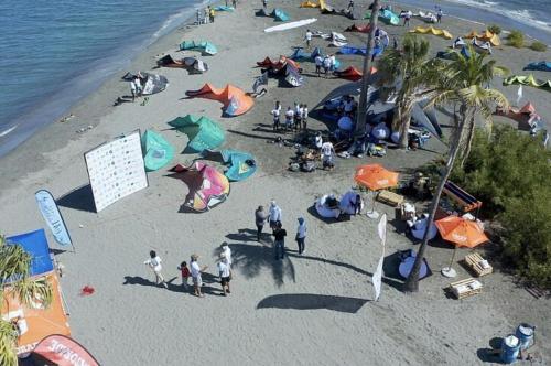 a group of people on a beach with umbrellas at Luxury Beach Villa with Private Pool, Jacuzzi, Beach Club Access with Restaurant & Adventure Nearby in Baní