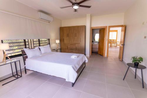 a bedroom with a white bed in a room at Luxury Beach Villa with Private Pool, Jacuzzi, Beach Club Access with Restaurant & Adventure Nearby in Baní