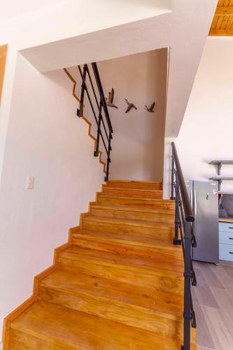 a staircase in a house with wooden floors at Luxury Beach Villa with Private Pool, Jacuzzi, Beach Club Access with Restaurant & Adventure Nearby in Baní