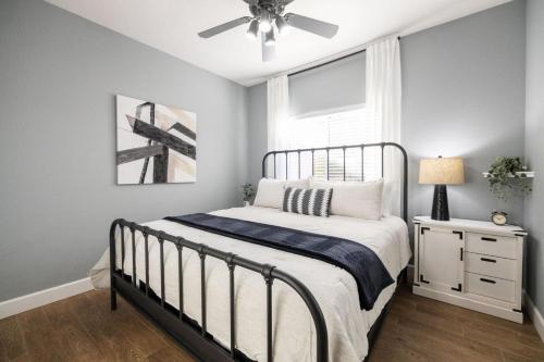 a bedroom with a bed and a ceiling fan at Gilbert Douglas in Gilbert