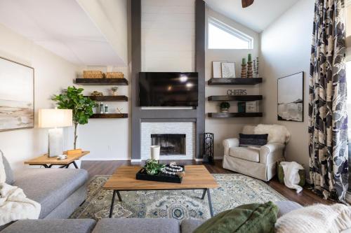 a living room with a couch and a fireplace at Gilbert Comstock in Gilbert