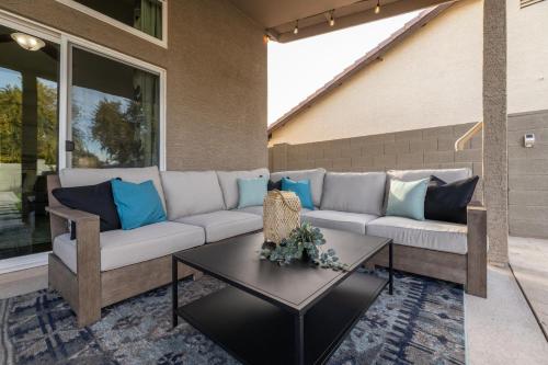 a patio with a couch and a table at Gilbert Comstock in Gilbert