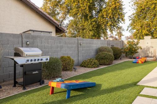 a backyard with a grill and a playground at Gilbert Comstock in Gilbert
