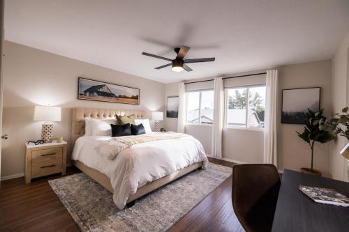 a bedroom with a bed and a ceiling fan at Gilbert Comstock in Gilbert