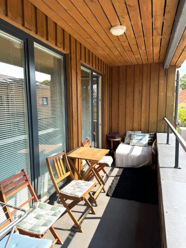 a porch with chairs and a table and a bed at Maria Rooms in Kuressaare