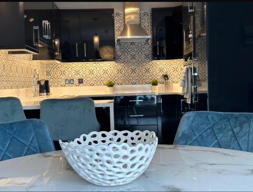 a kitchen with a white bowl on a table at Dublin Airport Large Superior Serviced Apartment - Sleeps 6 in Dublin