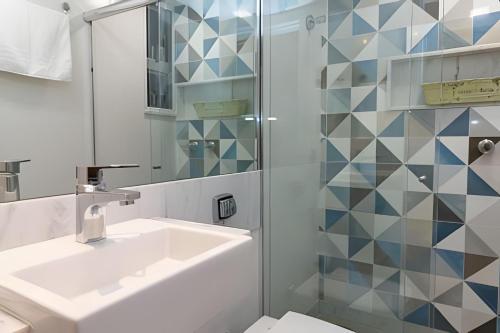 a bathroom with a sink and a shower at Apto Copacabana 200 da Praia - Suíte + Lava&Seca in Rio de Janeiro