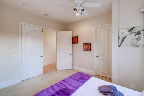 a bedroom with a large bed and two white doors at Villa Andalusia 6BR 5BA Luxury Jacuzzi Views and Games in Escondido