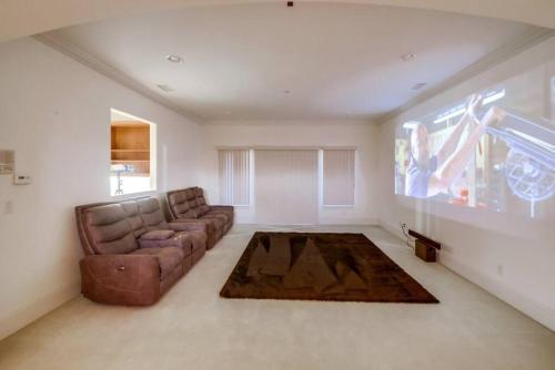 a living room with a couch and a large window at Villa Andalusia 6BR 5BA Luxury Jacuzzi Views and Games in Escondido