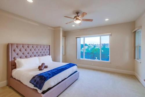 a bedroom with a large bed and a window at Villa Andalusia 6BR 5BA Luxury Jacuzzi Views and Games in Escondido