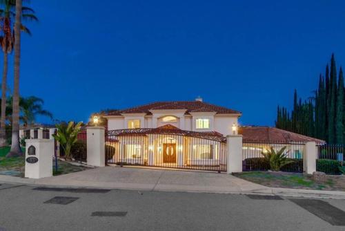 a large house with a gate in front at Villa Andalusia 6BR 5BA Luxury Jacuzzi Views and Games in Escondido
