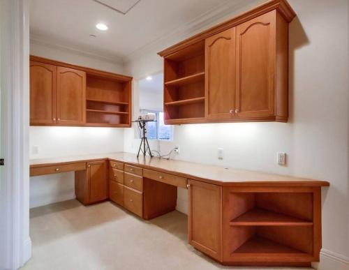a kitchen with wooden cabinets and a camera at Villa Andalusia 6BR 5BA Luxury Jacuzzi Views and Games in Escondido