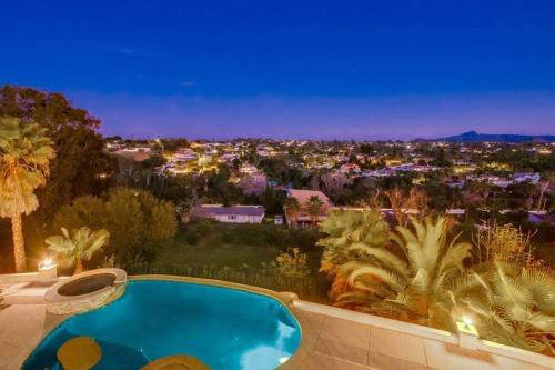 a view of a city at night with a swimming pool at Villa Andalusia 6BR 5BA Luxury Jacuzzi Views and Games in Escondido