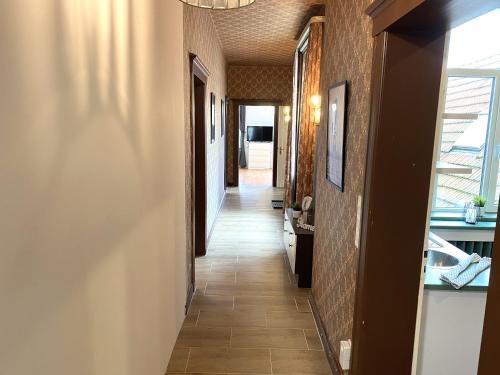 a hallway in a building with a long corridor at Handwerker Residenz Plus in Lengerich