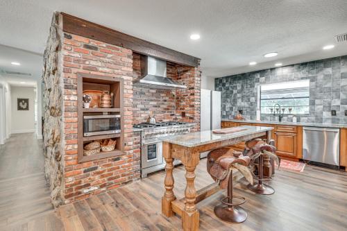 a kitchen with a brick wall and a counter top at Lutz Home with Game Room 7 Mi to Adventure Island! in Lutz
