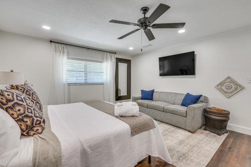 a bedroom with a bed and a couch and a ceiling fan at Lutz Home with Game Room 7 Mi to Adventure Island! in Lutz