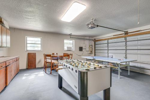 a large room with a table and a game room with counters at Lutz Home with Game Room 7 Mi to Adventure Island! in Lutz