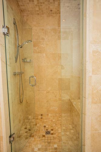 a bathroom with a shower with a glass door at The Atrium Resort in Grace Bay