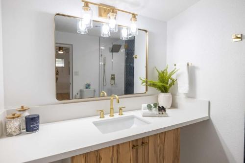 a bathroom with a sink and a large mirror at Tempe Wesleyan in Tempe