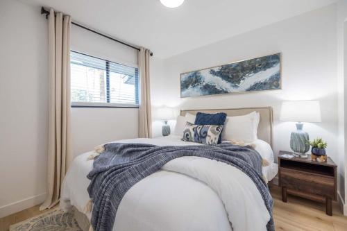 a white bedroom with a bed and a window at Tempe Wesleyan in Tempe