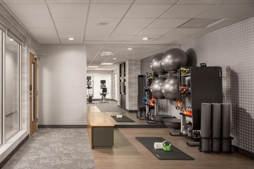 a room with a gym with exercise equipment on the wall at Fairfield by Marriott Inn & Suites Cullman in Cullman