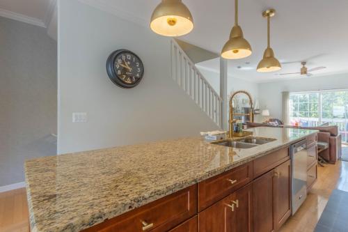 a kitchen with a counter and a clock on the wall at Butler Street Condo #16 - Walking Distance to downtown Saugatuck - Newer vacation rental in Saugatuck