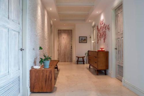 a hallway with a wooden table and a wooden dresser at Great Family-Friendly condo inside the gates in Punta Mita