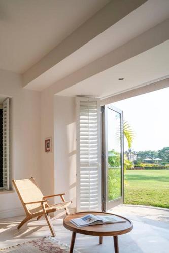 a living room with a chair and a table at Great Family-Friendly condo inside the gates in Punta Mita