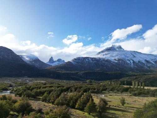 a valley with snow capped mountains in the distance at OUTSCAPE l Hermosa Cabaña familiar en Cerro Castillo in Villa Cerro Castillo