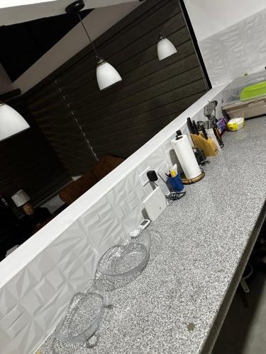 a kitchen counter with two wine glasses on it at Cabana Vergara Santa Fe in Santa Fe