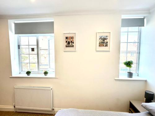 a bedroom with two windows and a bed at Spectacular Modern, Private Apartment,15 Mins To Central London in Hendon
