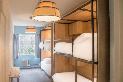 a room with three bunk beds in a room at ZAG Coliving Punta del este in Punta del Este