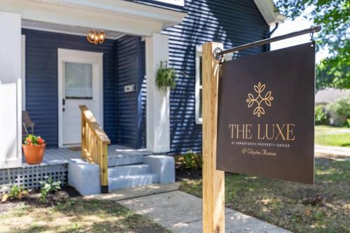 a house with a sign in front of a house at The Luxe Hot Tub Private Bar 12 Min to Horse Park in Georgetown