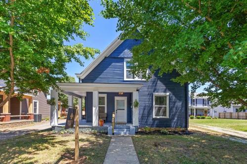 a blue house with a tree in front of it at The Luxe Hot Tub Private Bar 12 Min to Horse Park in Georgetown