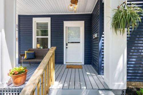 a blue house with a porch with a white door at The Luxe Hot Tub Private Bar 12 Min to Horse Park in Georgetown