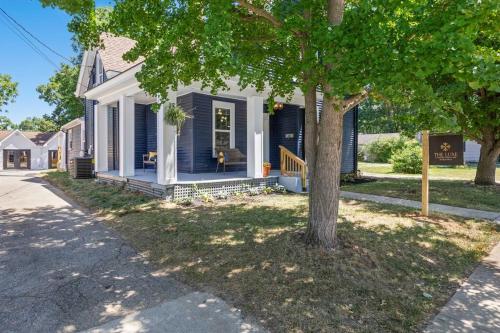 a blue house with a tree in front of it at The Luxe Hot Tub Private Bar 12 Min to Horse Park in Georgetown