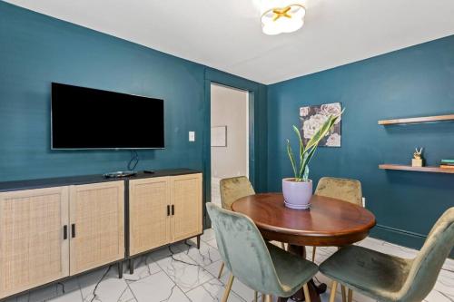 a dining room with a table and a tv at The Luxe Hot Tub Private Bar 12 Min to Horse Park in Georgetown