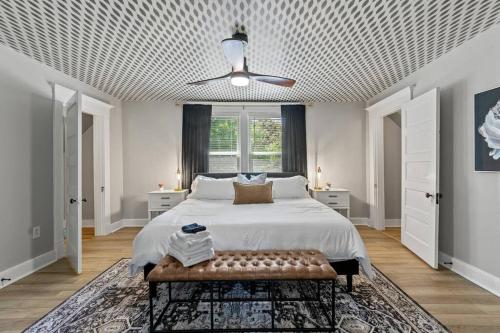 a bedroom with a bed with a coffered ceiling at The Luxe Hot Tub Private Bar 12 Min to Horse Park in Georgetown